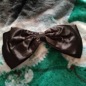 Claire's huge black satin bow
